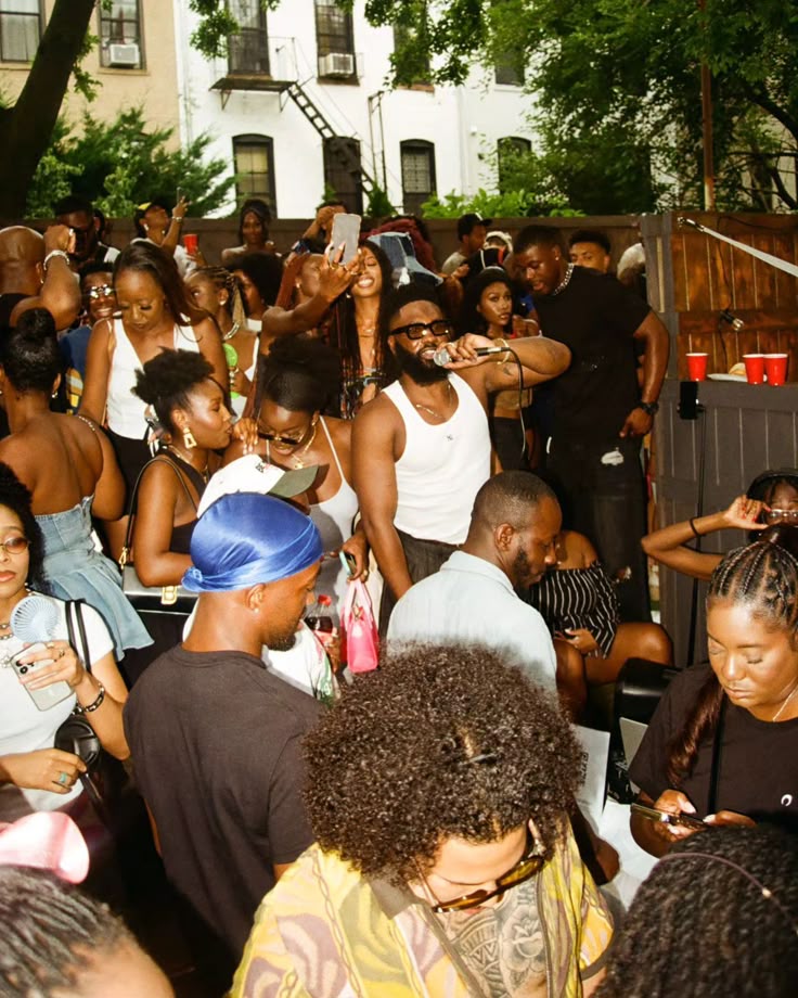 A backyard party with a host on the mic