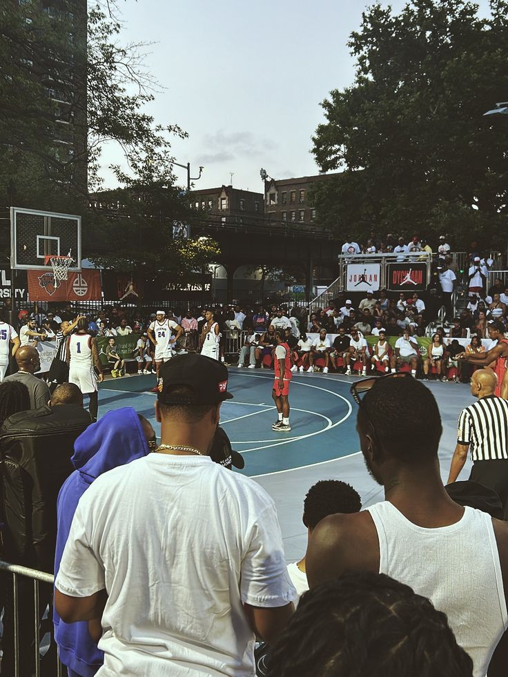 A crowd watching a streetball game