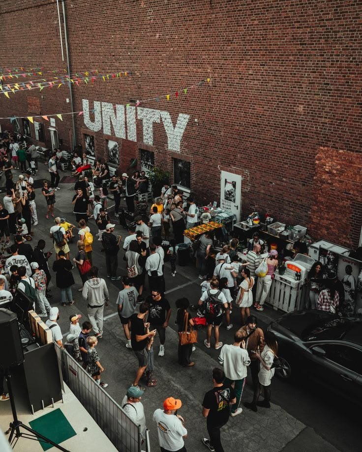 A block party in a brick alley with bunting